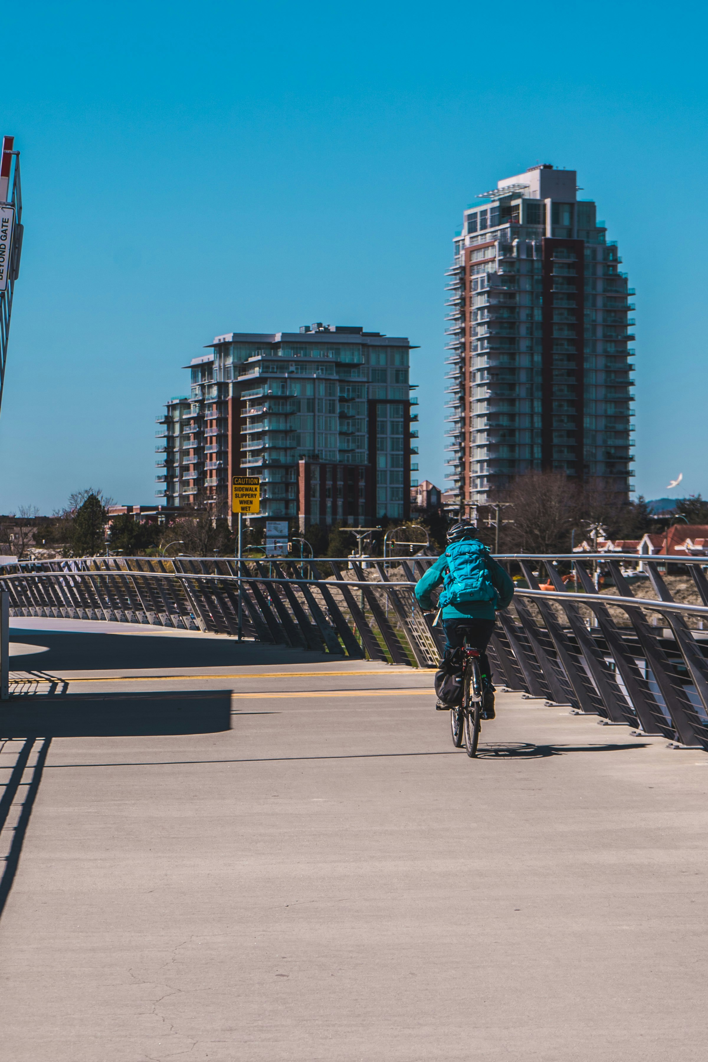 man in blue jacket riding bicycle on road during daytime